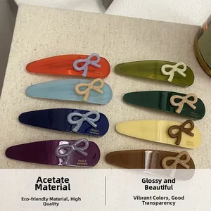 Detailed macro shot of acetate hair clips featuring various colorways and bow decorations