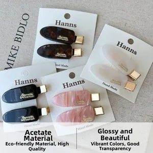 Detailed macro view of assorted acetate hair clips with tortoiseshell and marble textures