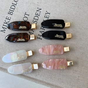 Elegant tortoiseshell and acetate hair clips with gold metal accents in four assorted colors