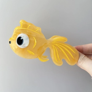 Vibrant gold goldfish hair claw clip made of acetic acid with elegant marble texture