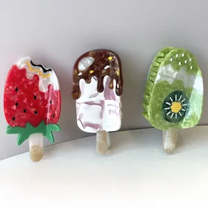 Detailed view of fruit ice cream hair claws in strawberry, kiwi and chocolate patterns