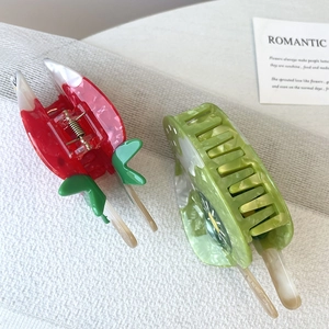 Close-up of cute strawberry and sunflower hair claws with clear acetate texture