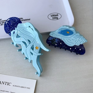 Blue ocean-themed jellyfish and seashell hair claws with glitter and star accents