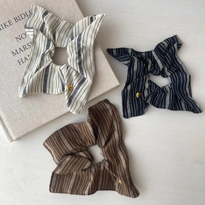 Textured striped fabric hair scrunchies in cream and brown with gold heart charms