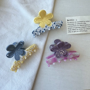Three acetate flower hair claws in leopard, floral, and marble patterns for women