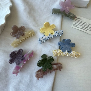 Collection of flower acetate hair claws in various marble and leopard patterns