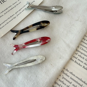 Acetate fish-shaped hair clips set with rhinestone eyes and diverse marble patterns