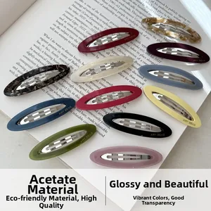 Close-up of colorful acetate oval hair clips with elegant glossy finish and patterns