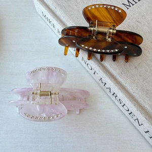 Elegant acetate bow hair claws with rhinestones in tortoise shell and marble purple patterns