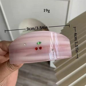 Detailed view of pink marble claw clip with cherry rhinestones, weight 19g, 9cm length