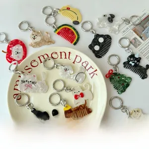Detail view of acetate animal and fruit comb charms with high gloss shell texture