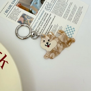 Close-up of shiba inu charm made of brown marbled acetate on a metal keyring