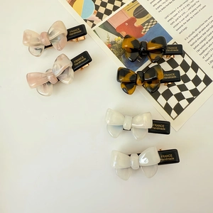 Set of 6 acetate bow hair clips in marble and tortoiseshell patterns with metal base