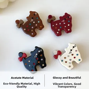 Detailed view of cat-shaped acetate hair clips with colorful rhinestones and bows
