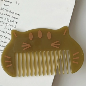 Cute cat shaped hair comb for kids in a translucent olive brown resin finish