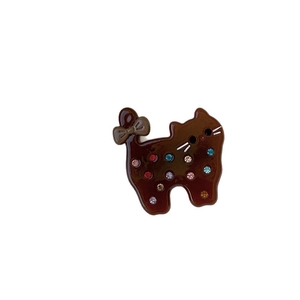 Chic acetate cat hair clip with colorful rhinestones and a bow on a white background