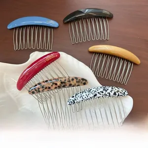 Close-up of handmade six-tooth acetate hair combs in six elegant marbled colors