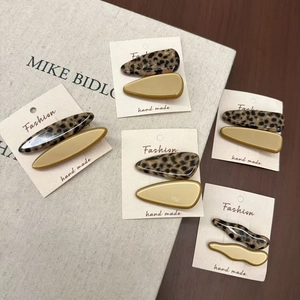 Five pairs of tortoiseshell acetate hair clips in assorted geometric shapes on cards