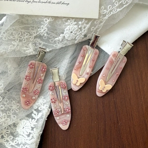 Pink marble acetate hair clips set with rhinestone flowers and yellow butterflies
