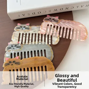 Close-up of four cat-shaped acetate hair combs with marble and amber patterns on wood