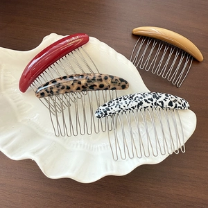 Set of four handmade acetate hair combs in various colors with silver metal teeth