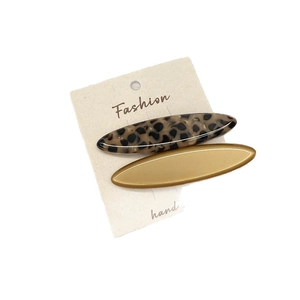 Tortoiseshell acetate and gold metal hair clip set on display card for hair styling