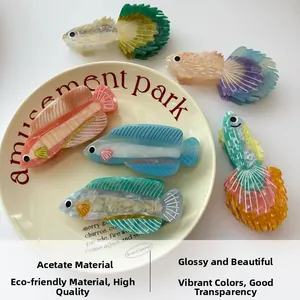 Détails macro des pinces à cheveux en acétate écologique en forme de poisson coloré