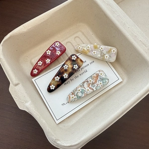 Set of four jelly floral acetate triangle hair clips in various marble and retro colors