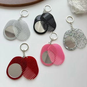 Five assorted glitter mirror and comb keychain sets arranged on a clean white background