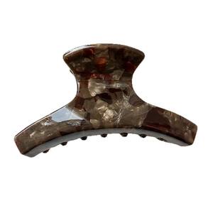 Classic tortoiseshell acetate hair claw clip with mottled brown and beige pattern design