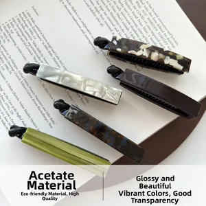 Macro shot of acetic acid banana hair clips in tortoiseshell and marble patterns on a book