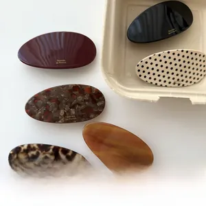Detail of elegant oval acetate hair barrettes in various marble and tortoiseshell patterns