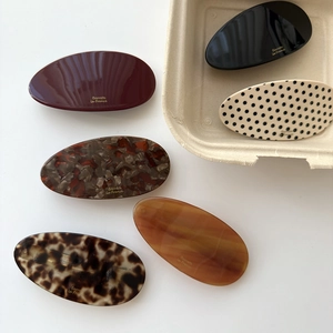 Elegant acetate oval hair clips set in various marble patterns and solid colors