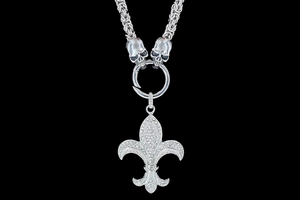 Detail of gothic punk necklace with rhinestone skull and fleur-de-lis pendant on thick chain