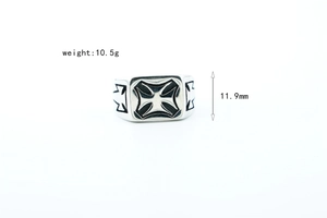 Macro shot of stainless steel punk ring featuring a black oxidized Maltese cross design