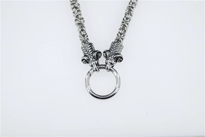 Detail of vintage silver double ram heads necklace with Byzantine chain and metal ring