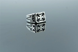 Macro shot of stainless steel iron cross ring with black enamel finish and reflections