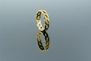 Detailed close-up of golden Cuban chain link ring on a reflective mirror surface