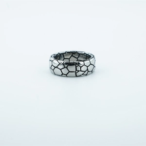 Vintage stainless steel wide ring with black cracked stone pattern on white background