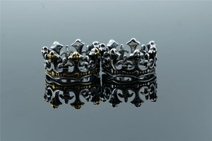Close-up of gothic crown rings in vintage silver and gold-toned stainless steel