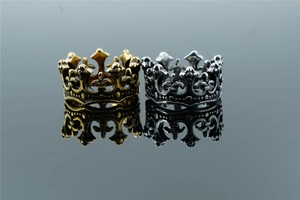 Close-up of gold and vintage silver crown rings with hollow engraving and mirror reflection
