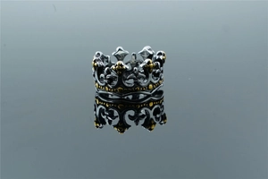 Detailed macro view of vintage crown ring with fleur-de-lis pattern and silver finish