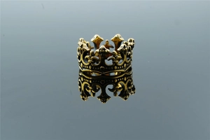 Detailed macro view of a vintage gold crown ring with intricate gothic hollow patterns