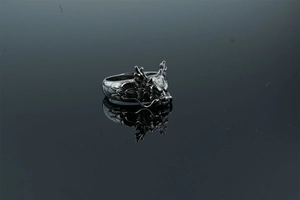 Macro detail of retro dragon head ring featuring intricate scales and antique steel finish