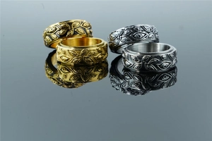Macro detail of rotating stainless steel rings with vintage eye relief textures in four colors