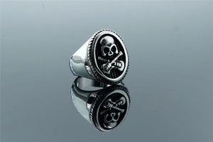 Detailed macro view of punk skull and guitar embossing on vintage stainless steel ring