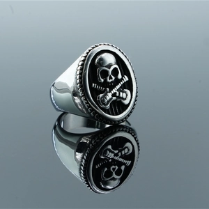 Punk style stainless steel ring featuring skull and crossed guitars with vintage finish