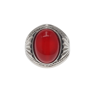 Vintage stainless steel ring featuring a large oval red gemstone with detailed engraved patterns