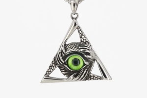 Close-up of All-seeing Eye pendant with green pupil and metallic hand details