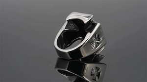 Detailed macro view of punk style titanium steel ring with iron cross relief and retro finish